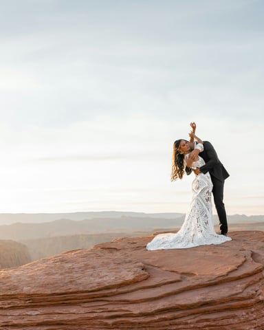 Couple eloping at golden sunrise on red rock canyon