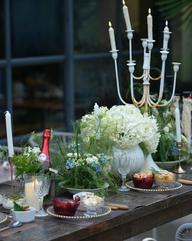 Elegant outdoor candlelit dinner table with flowers